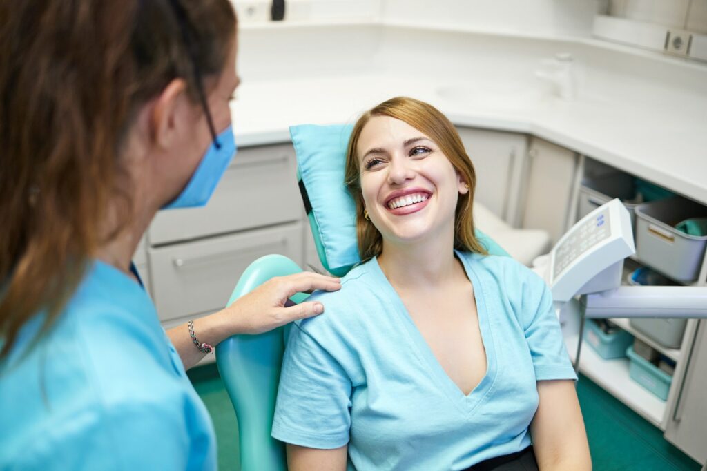 Dentist talking to female patient
