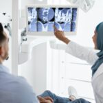 Root Canal Treatment. Muslim Female Dentist Showing Xray Picture On Digital Monitor