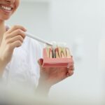 Smiling Dentist Explaining Tooth Implantation
